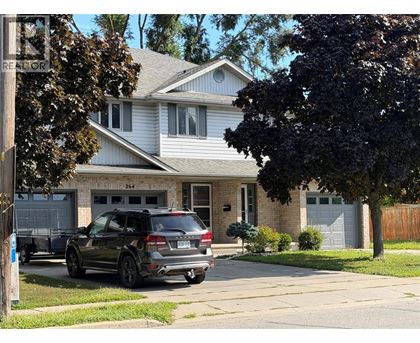 A house with a car parked in front of it.