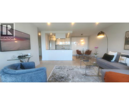 A living room with a blue armchair and a glass coffee table.