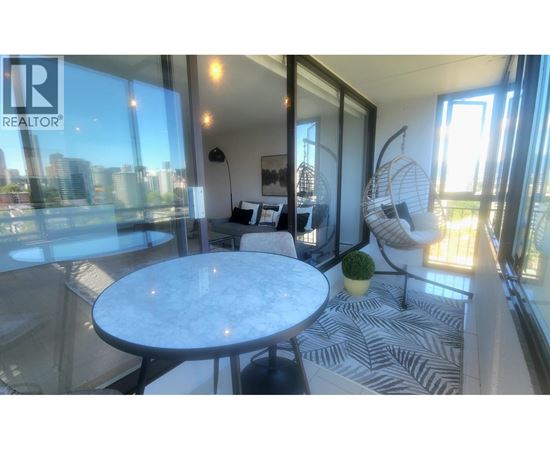 A living room with a marble table and a zebra print rug.