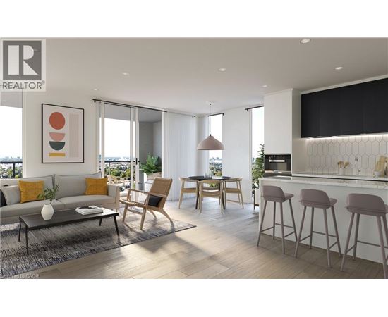 A modern living room with a grey sofa, a wooden chair, and a bar area with stools.
