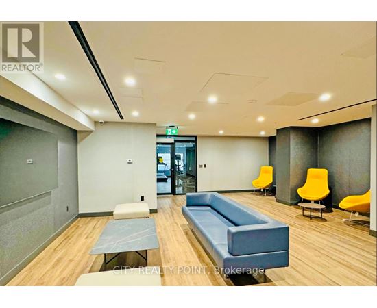 A conference room with a long table and chairs.