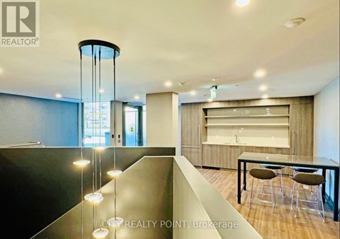 A modern dining area with a glass table and chairs.