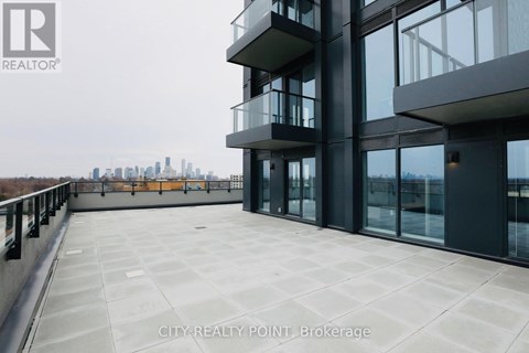 A modern building with a balcony overlooking a city skyline.