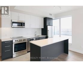 A modern kitchen with a stove top oven, microwave, and a counter top.