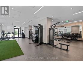 A gym with a variety of equipment including treadmills, weights, and exercise machines.