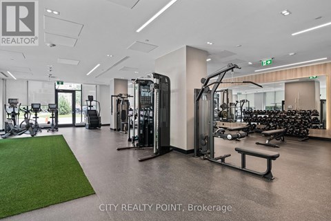 A gym with a variety of equipment including treadmills, weights, and exercise machines.