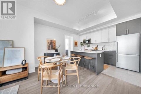 A modern kitchen with a dining table set for four.
