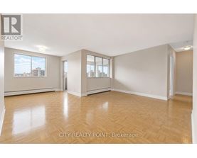 A spacious room with wooden flooring and large windows at City Realty Point, Brokerage.