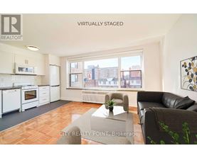A virtual staged living room with a City Realty Point Brokerage logo.