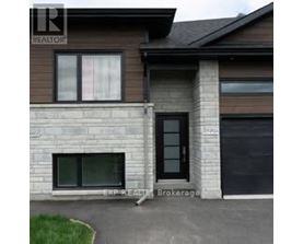A house with a brown roof and a sign that says REALTOR.
