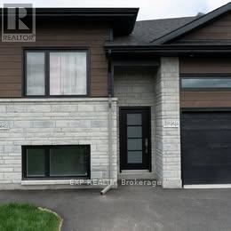 A house with a brown roof and a sign that says REALTOR.