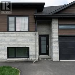 A house with a brown roof and a sign that says REALTOR.