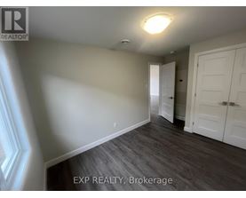 A room with a wooden floor and white walls.