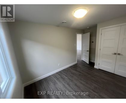 A room with a wooden floor and white walls.