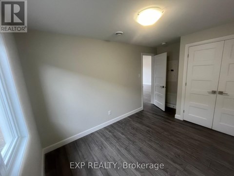 A room with a wooden floor and white walls.
