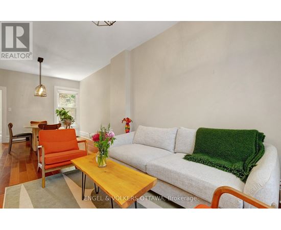 A living room with a white couch and a wooden coffee table.