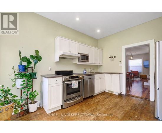 A kitchen with white cabinets and stainless steel appliances.