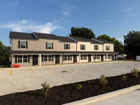 A building with a parking lot in front of it.