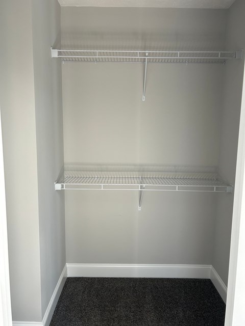 Empty white shelving unit in a room.