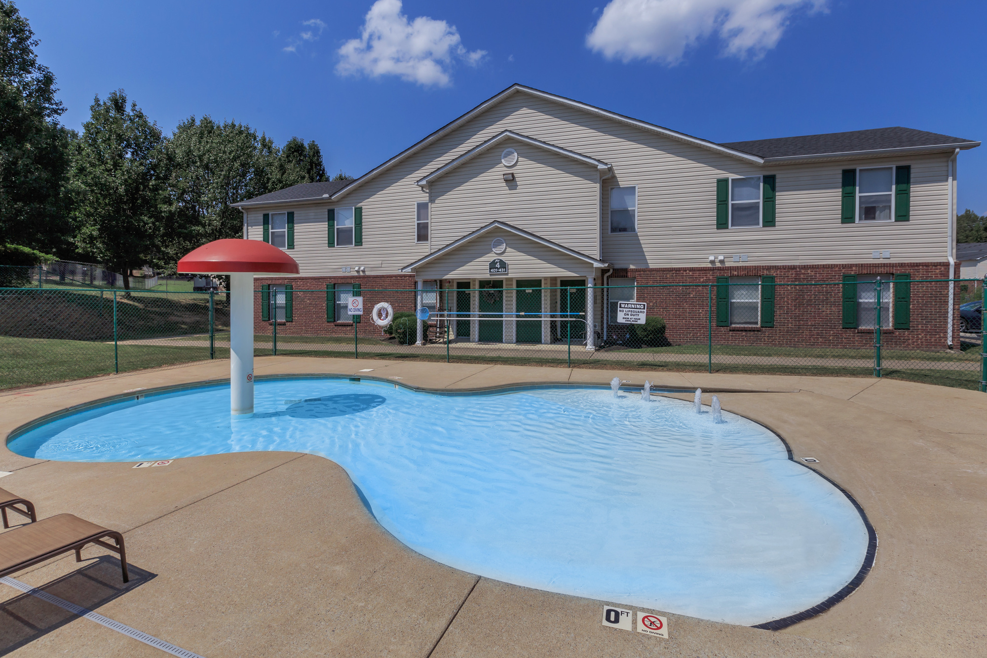 Kiddie Pool with mushroom-shaped figure inside and building in the background