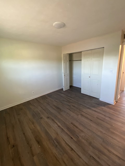 A room with wooden floors and a white ceiling.