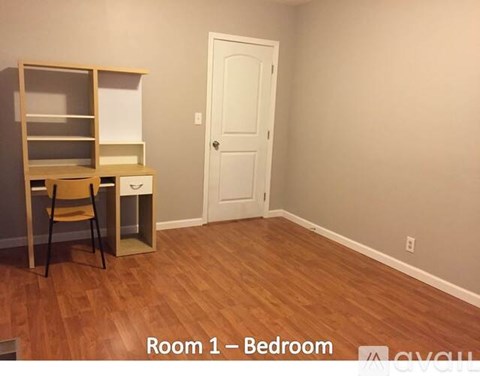 A room with a bed, a chair, and a shelf.