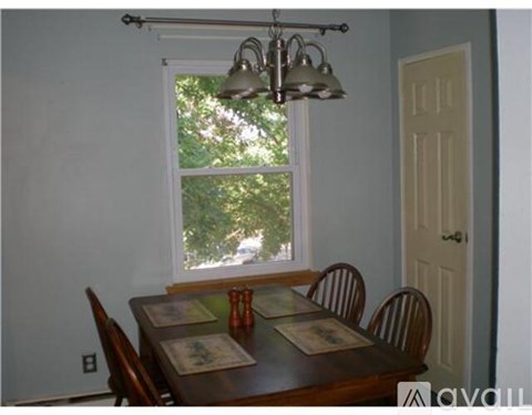 A dining room with a table set for four.