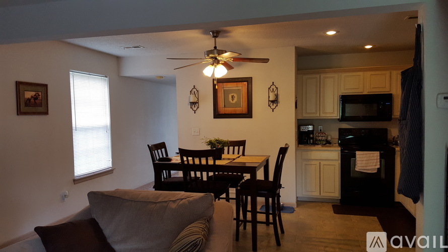 A living room with a dining table and chairs.