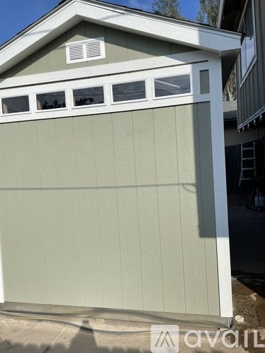 A garage door with a window on top.