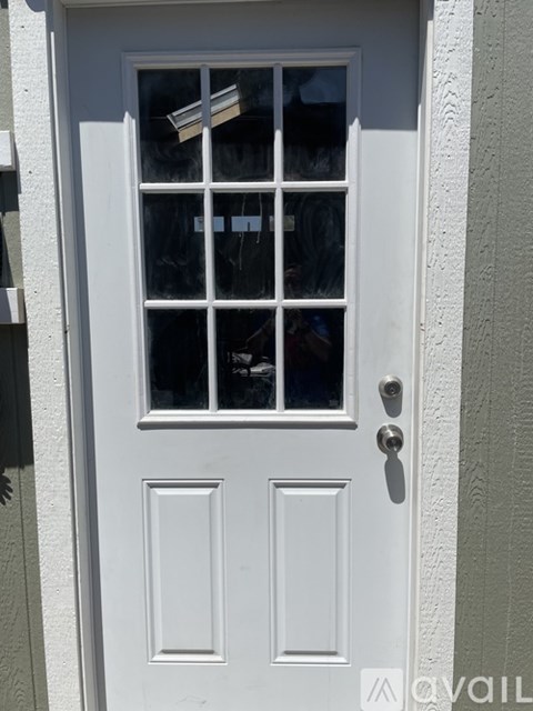 A white door with a glass window and a handle.