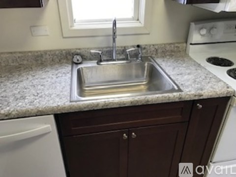 A kitchen with a sink and a window.