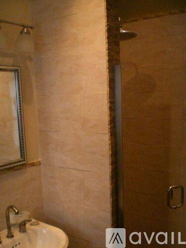 A bathroom with a sink and a shower.