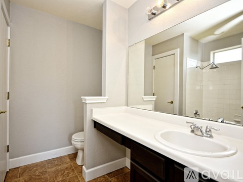 A white bathroom with a toilet and sink.