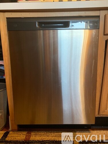 A stainless steel dishwasher is in a kitchen.