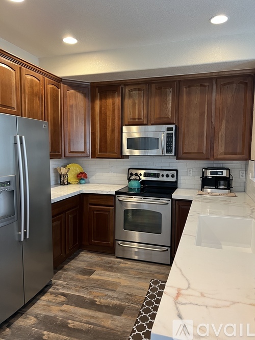 A kitchen with wooden cabinets and stainless steel appliances.