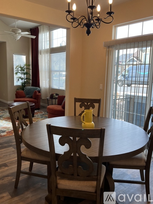 A dining room with a round table and chairs.