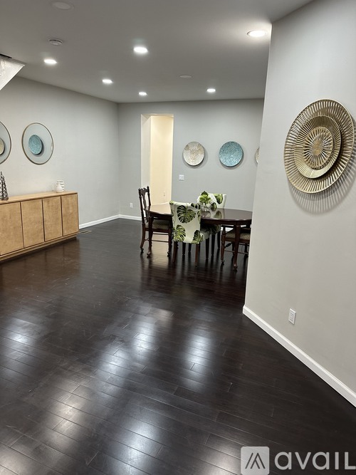 A dining room with a wooden table and chairs.