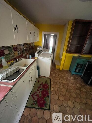 A kitchen with a sink and a window.