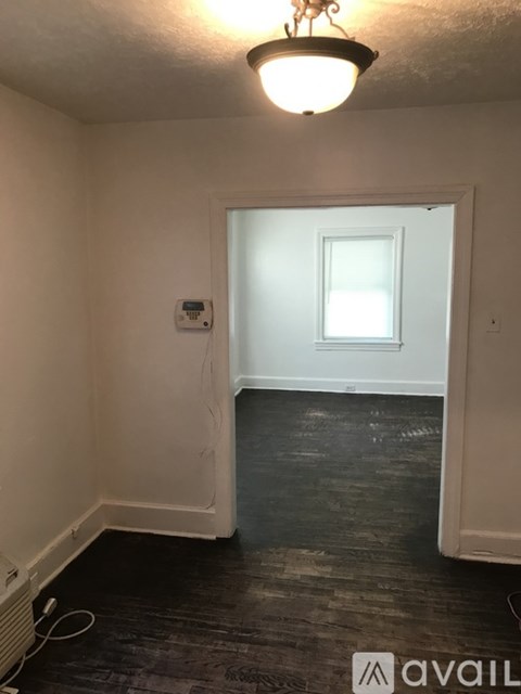 A room with a white door and a window.
