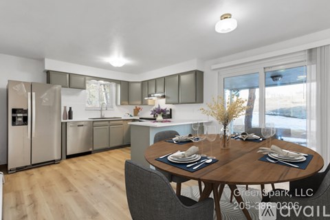 A modern kitchen with a dining table set for two.