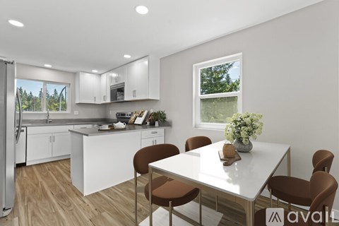 A modern kitchen with a dining table set for four.