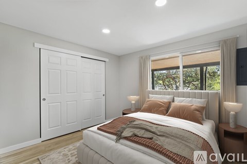 A bedroom with a large bed and a sliding door.