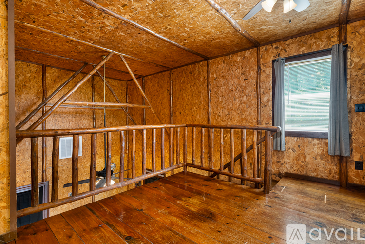 A room under construction with wooden floors and walls.