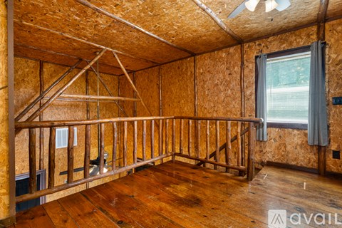 A room under construction with wooden floors and walls.