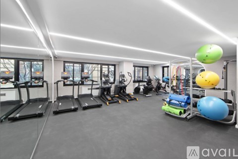 A gym with treadmills, exercise balls, and other equipment.