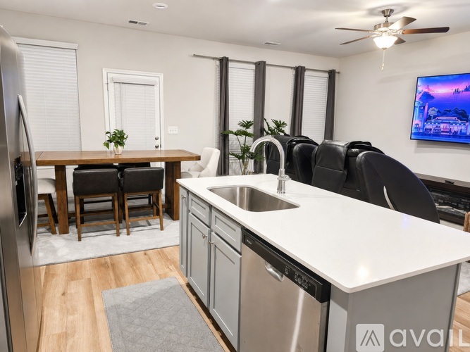 A modern kitchen with a dining table and chairs.