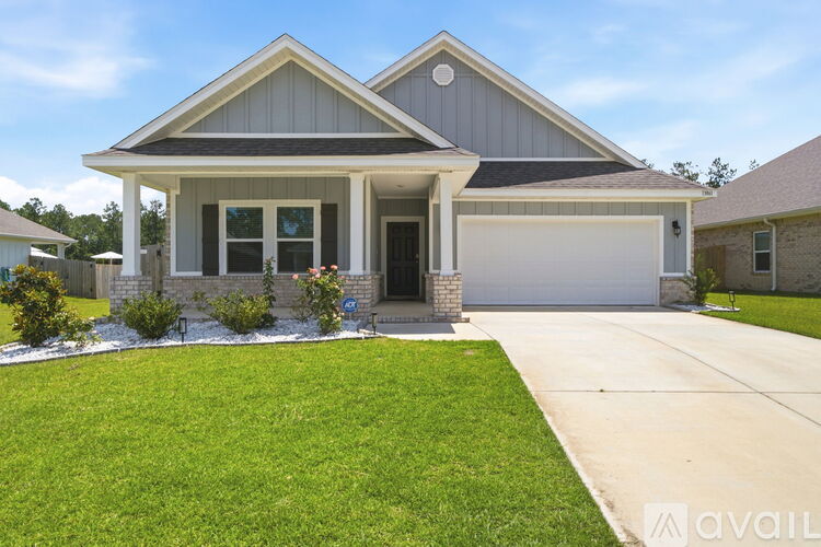 A house with a grey roof and a white garage door.