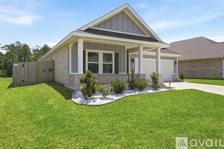A house with a grey roof and white trim is for sale.