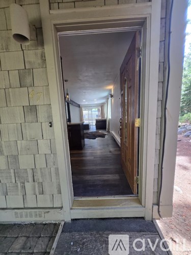 A hallway with a doorway leading to another room.