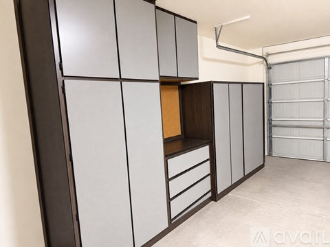 A kitchen with white and brown cabinets and a drawer is shown.
